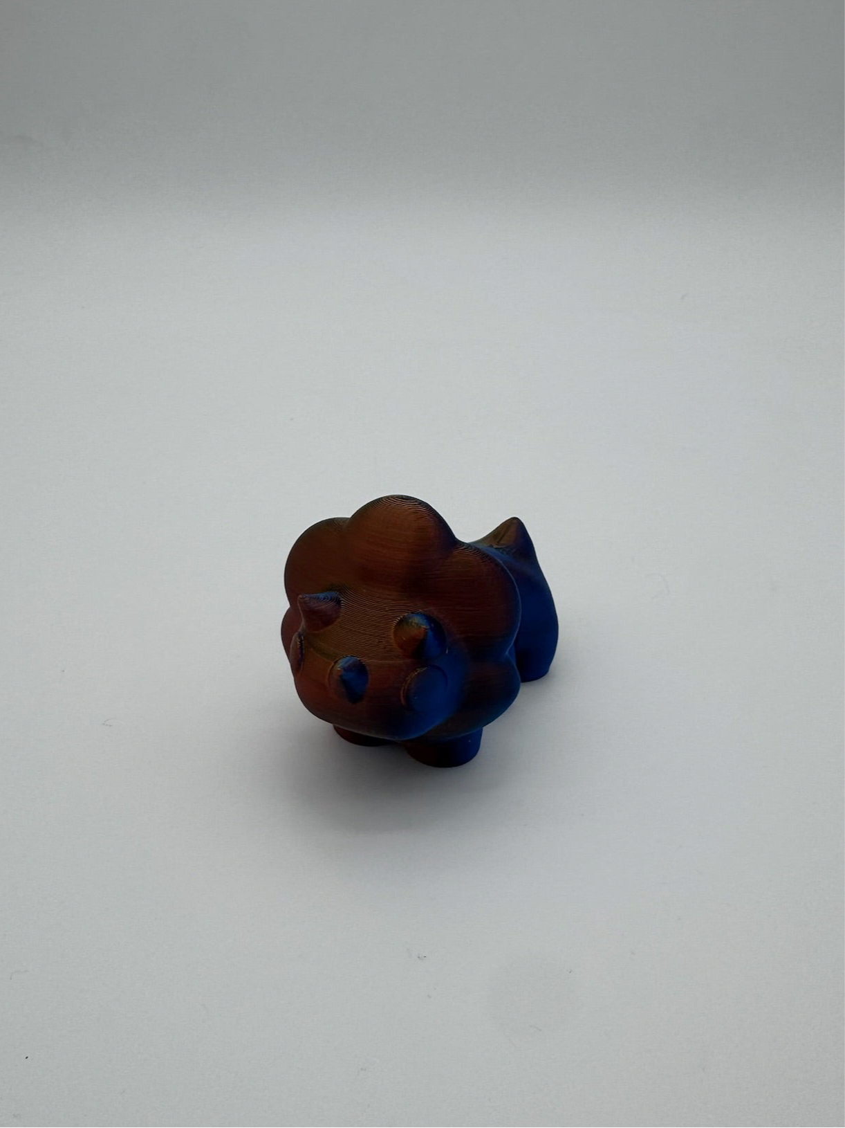3D printed three-horned triceratops model showcasing smooth joint movement.