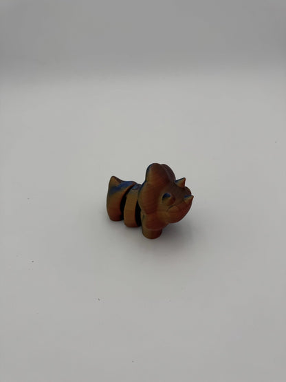 Stylized prehistoric dinosaur desk toy crafted from 100% recycled plastic.